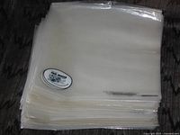 Stack of clear polyethylene outer record sleeves with Vinyl Museum sticker on top unit