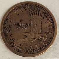 Coin reverse showing flying eagle, stars, and inscriptions UNITED STATES OF AMERICA, E PLURIBUS UNUM, ONE DOLLAR.
