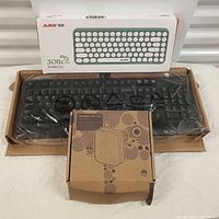 Lot with Ajazz 308i keyboard box on top, Lenovo keyboard in plastic wrap underneath in brown box, and Huawei MT130U modem box in front.