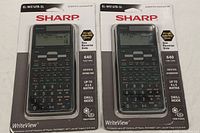 Front view of two Sharp EL-W516TB-SL scientific calculators in sealed packaging showing model details and features.