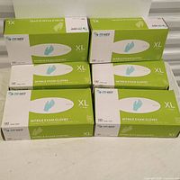 Six boxes of XL nitrile exam gloves arranged in two rows of three boxes each, showing front and side panels.