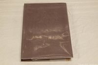 Brown stamp album containing the collection.