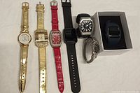 All six watches in a row showing variety of styles and colors.
