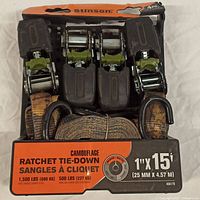 Photo of 4 camouflage ratchet tie-down straps in original Stinson packaging showing ratchet handles, hooks, and strap wound inside
