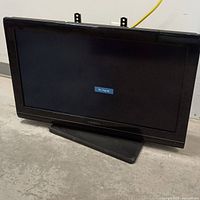 Front view of 37 inch Insignia TV with screen showing 'No Signal' message on black screen.