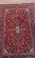 Full view of vintage Persian area rug approximately 5x3 ft showing central medallion and floral patterns in red, cream, blue and gold tones.