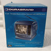 Box front showing product image and basic features describing a 5 inch portable black and white television with AM/FM radio, earphone jack, external antenna jack with adapters, and 3-way power operation (AC adapter, car cord, and 10 size C batteries not included).