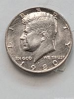 Obverse of the Kennedy Half Dollar, showing the profile of John F. Kennedy and the date 1980, with the filled 'P' mint mark error visible.
