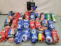 Overview photo showing the full assortment of 25 mini boxing gloves with various flag and football club designs.