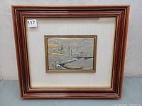 Framed entire plaque with wood and gold trim front view showing lot 117 sticker