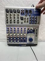 Front full view showing all input and output options, control knobs and main mixer section.