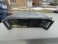 Front view of Lantek PPX-900 power amplifier showing control knobs, power switch, LED indicators and cooling vents.