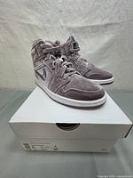 Oblique side view of the Air Jordan 1 Mid SE women's sneaker in velvet upper on white box