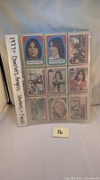 Binder sleeve page containing 9 Charlie's Angels collector cards/stickers, featuring images of angels and scenes with colorful borders from the 1977 TV series.