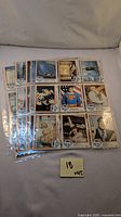 Photo of 18 trading cards and stickers from Superman the Movie collection, neatly arranged in plastic sleeves, showing various characters and scenes including Christopher Reeve as Superman.