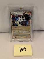 Close-up photo showing the Lucario LV.X holographic Pokémon card in a protective plastic case.