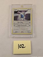Front view of Lugia Holo Pokémon card in protective case showing card details and condition