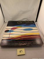 Stack of 8 vinyl records showing Carpenters album cover on top with abstract colorful line design