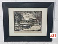 Framed woodcut print on wall