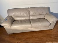 Front view of beige leather couch