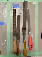 Photo of five files including wood rasp and various metal files with different handles.