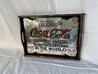 Photo shows rectangular wooden framed Coca Cola serving tray with vintage mirrored advertisement graphics.