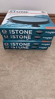 Stack of four boxes of 8 inch disc air stones labeled Active Aqua, each box shows an image of the round black air stone.