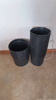 Stack of 25 new black 3.96 gallon soft pots, ribbed sides, flexible plastic material, slightly shallow depth.
