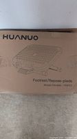 Cardboard box showing Huanuo brand and product model HNFR3 foot rest.
