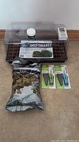 Full lot showing cloning tray with clear dome lid, Gro-Smart insert tray, small jar of Root Max cloning gel, box of Root Farm PH test strips, bag of Grodan micro plugs, and two pruners in original packaging.