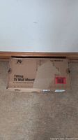 Boxed Mounting Dream Tilting TV Wall Mount with text and logo visible on box top.