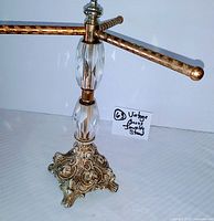 Top view showing the three brass arms with hammered finish and upper crystal segment on the stem