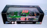 Front angle view of the die cast Bobby Labonte #18 car in original black display box with clear plastic window, box labeled Revell 1996 edition.
