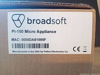 Label on box showing Broadsoft logo, PI-150 Micro Appliance with MAC address and manufacturing by Patton Electronics Co.