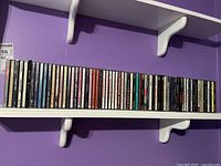 Shelf with the CDs displayed with titles visible on spines.