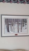 Framed winter woodland print of trees in snow, showing the full artwork and frame.
