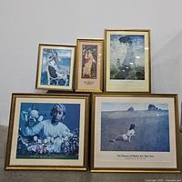 Five framed art prints arranged with three on top and two beneath, showing portraits of girls, floral theme, and well-known artwork including Monet and Wyeth