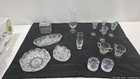 Full view of the lot showing all glass items placed on a black surface against a white background.