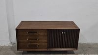 Full front view of the Lane mid-century walnut server cabinet showing three drawers and door.