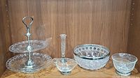 Overview photo showing all four pieces of the lot: two-tier server, silver rimmed crystal bowl, footed etched condiment bowl, and heart-shaped sauce bowl.