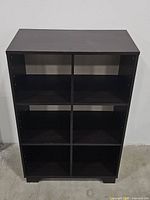 Front view of the black bookshelf showing six equal compartments in a 2x3 grid.