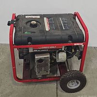 Front-side view showing red frame, tire, engine, and black fuel tank with label.