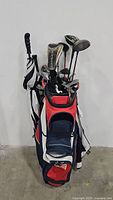 Full view of Callaway golf cart bag filled with golf clubs and black and white umbrella attached