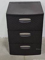 Front view of the Sterilite 3-drawer plastic storage unit, closed drawers, showing brown textured weave design and silver handles.