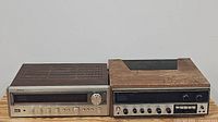 Photo showing both stereo receivers side by side on a wooden surface, Onkyo to the left and Kenwood to the right, visible condition and size comparison.