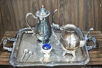 Full set including tray, tea pot, coffee pot, salt cellar with blue insert, and two spoons.