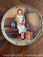 Front image of 'A Young Girl's Dream' plate featuring young girl sitting with luggage