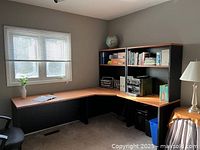 Assembled L-shaped desk in corner with hutch units, showing overall layout and finishes
