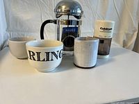 French coffee press, Cuisinart mini chopper, and three coffee mugs front view