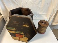 Hexagon wooden box with lid, painted with Asian style landscape and building, alongside a small carved wooden container with lid.